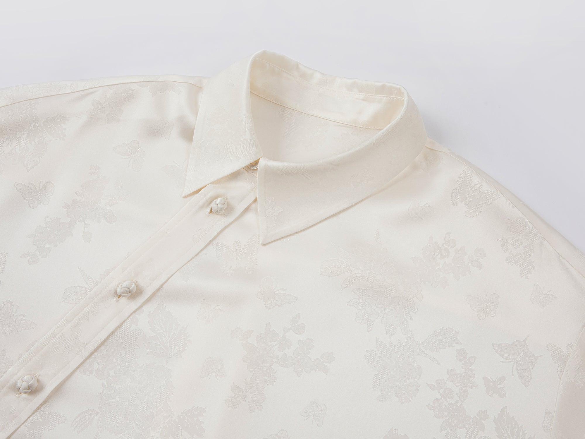 Modern chinese-style embroidered button shirt with tie hem detail