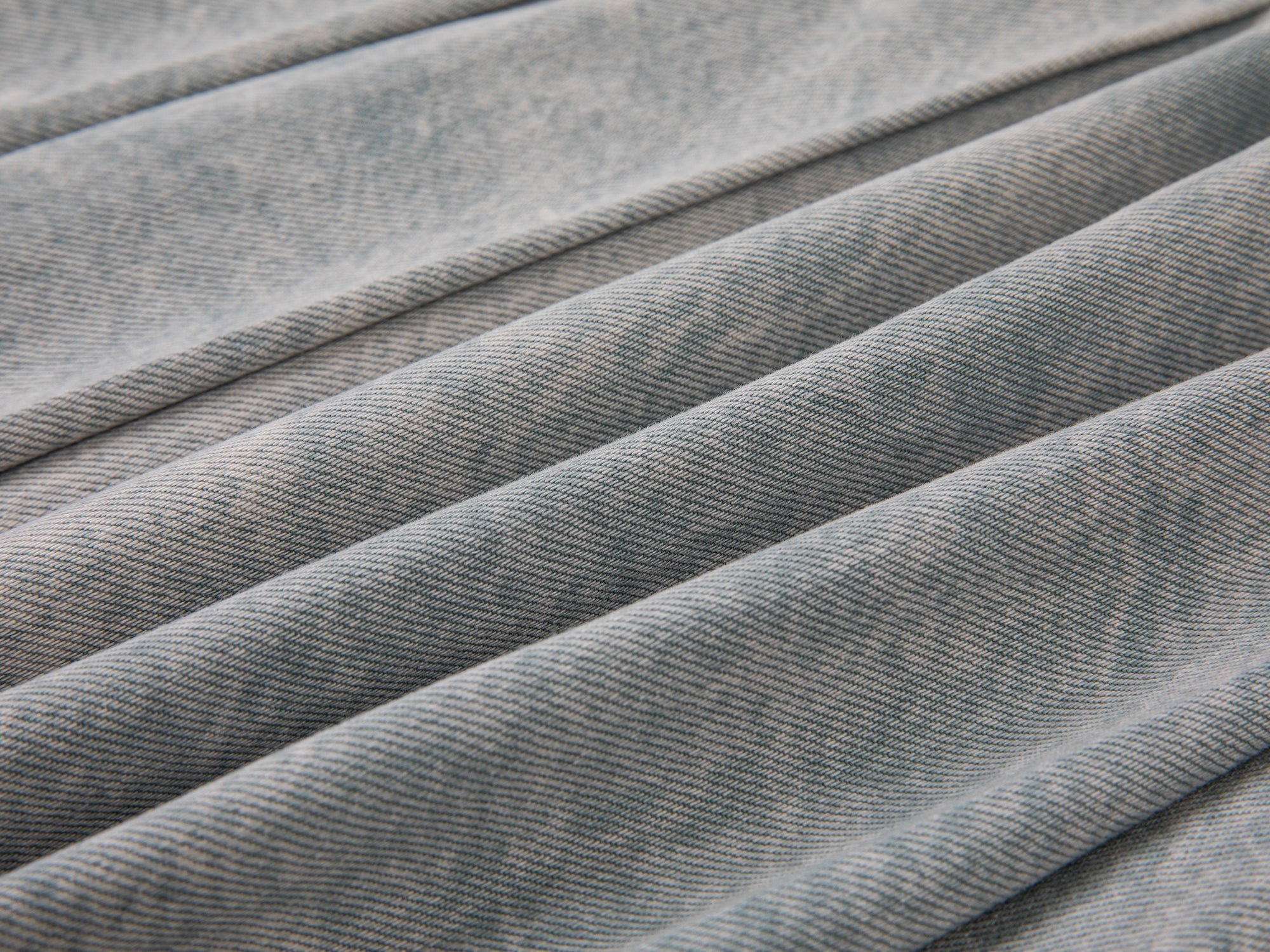 Raw edge pleated washed denim skirt