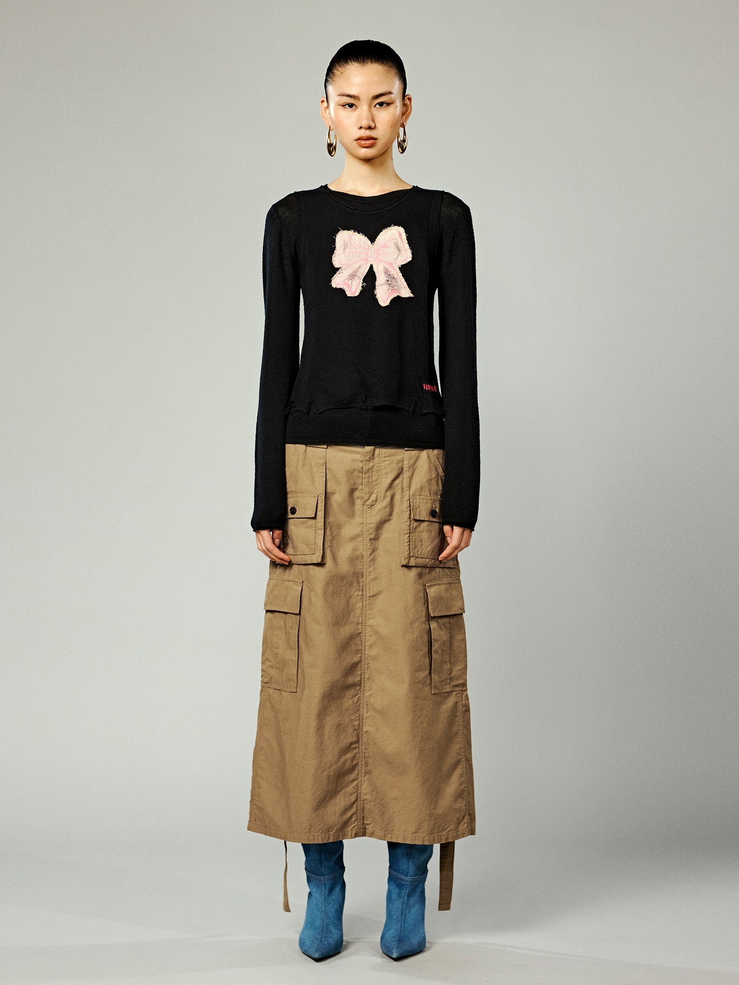 Distressed faux-layered bow sweater