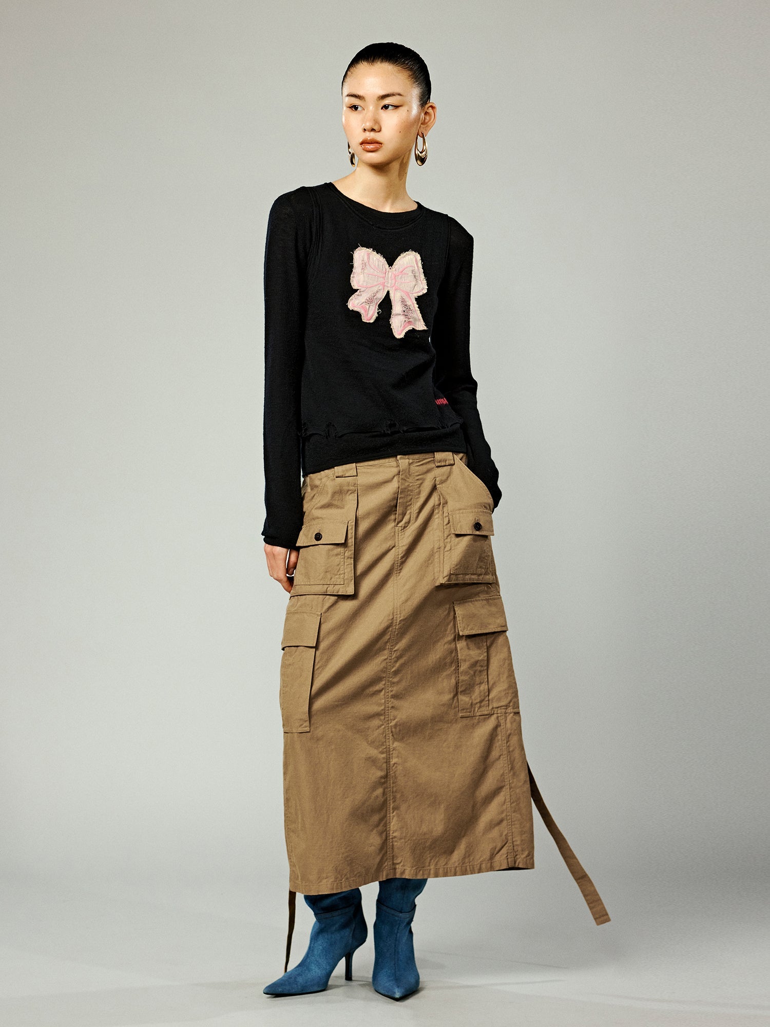 Distressed faux-layered bow sweater