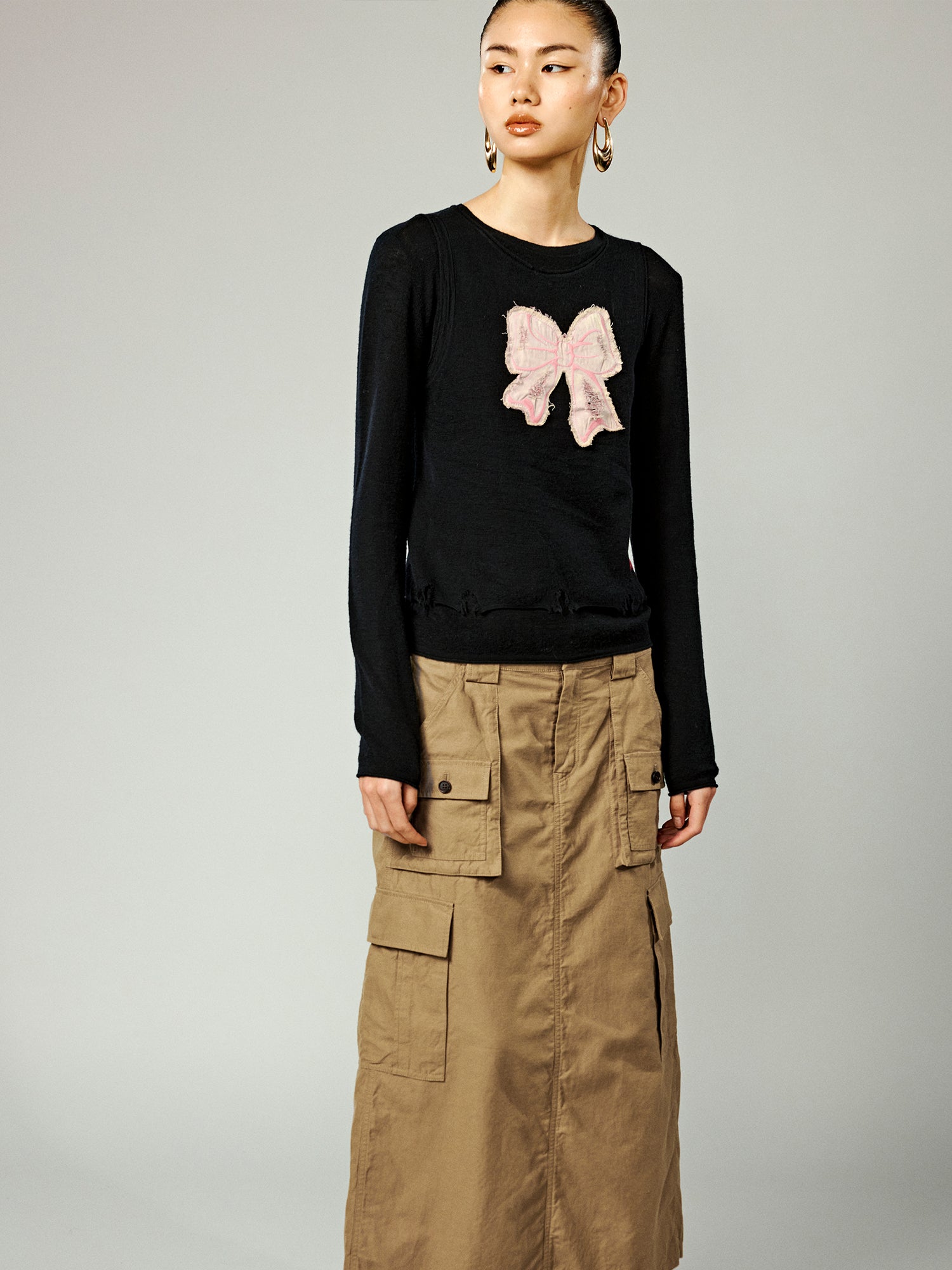 Distressed faux-layered bow sweater