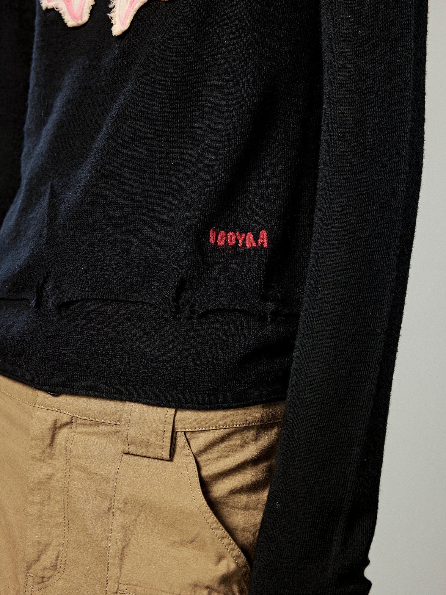 Distressed faux-layered bow sweater