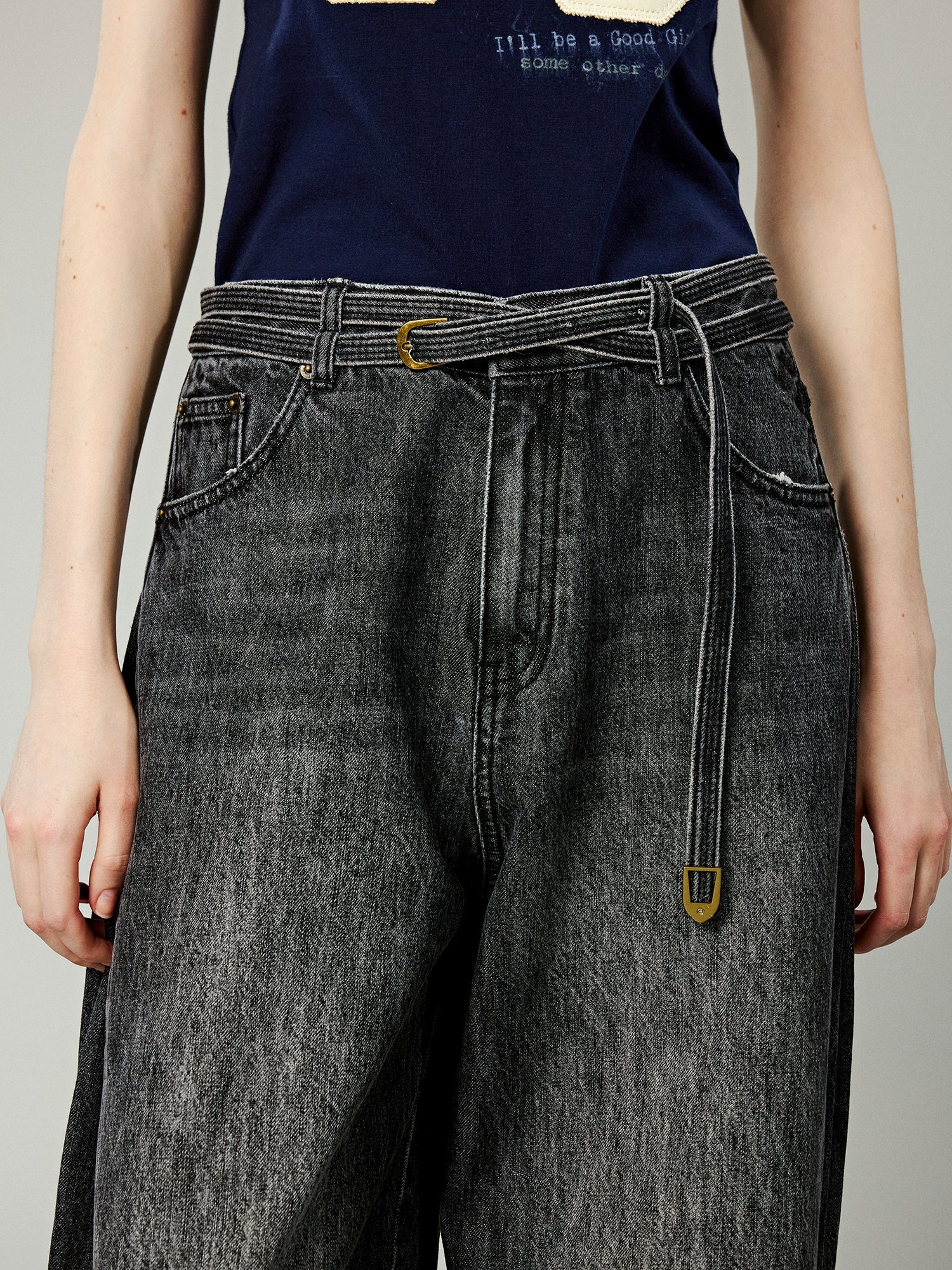 Structured side-pleat belted jeans