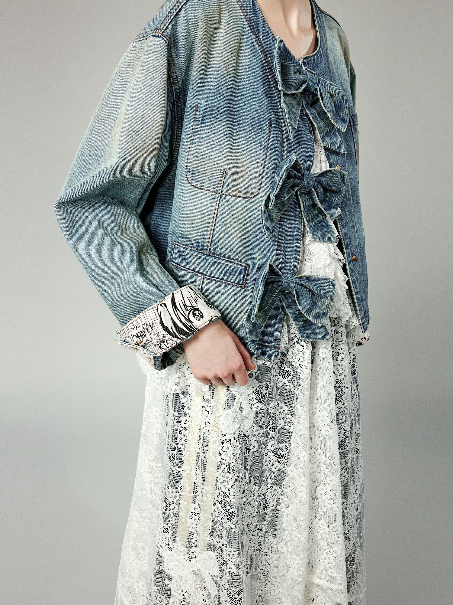 Denim jacket with bow fastenings