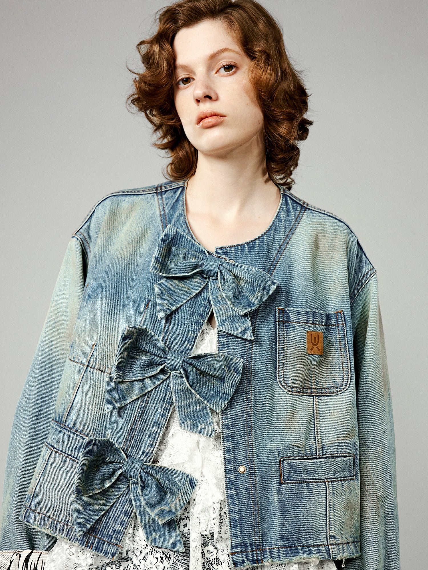 Denim jacket with bow fastenings