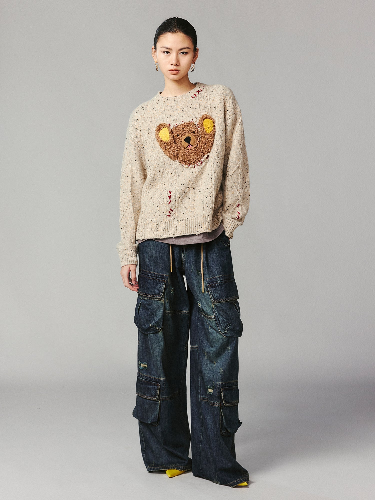 Teddy bear peeking through sweater