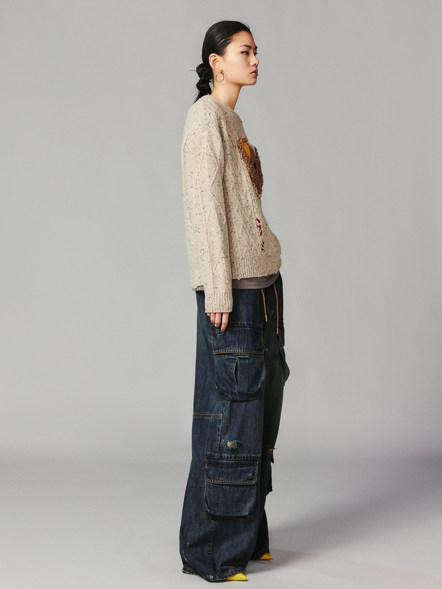 Teddy bear peeking through sweater