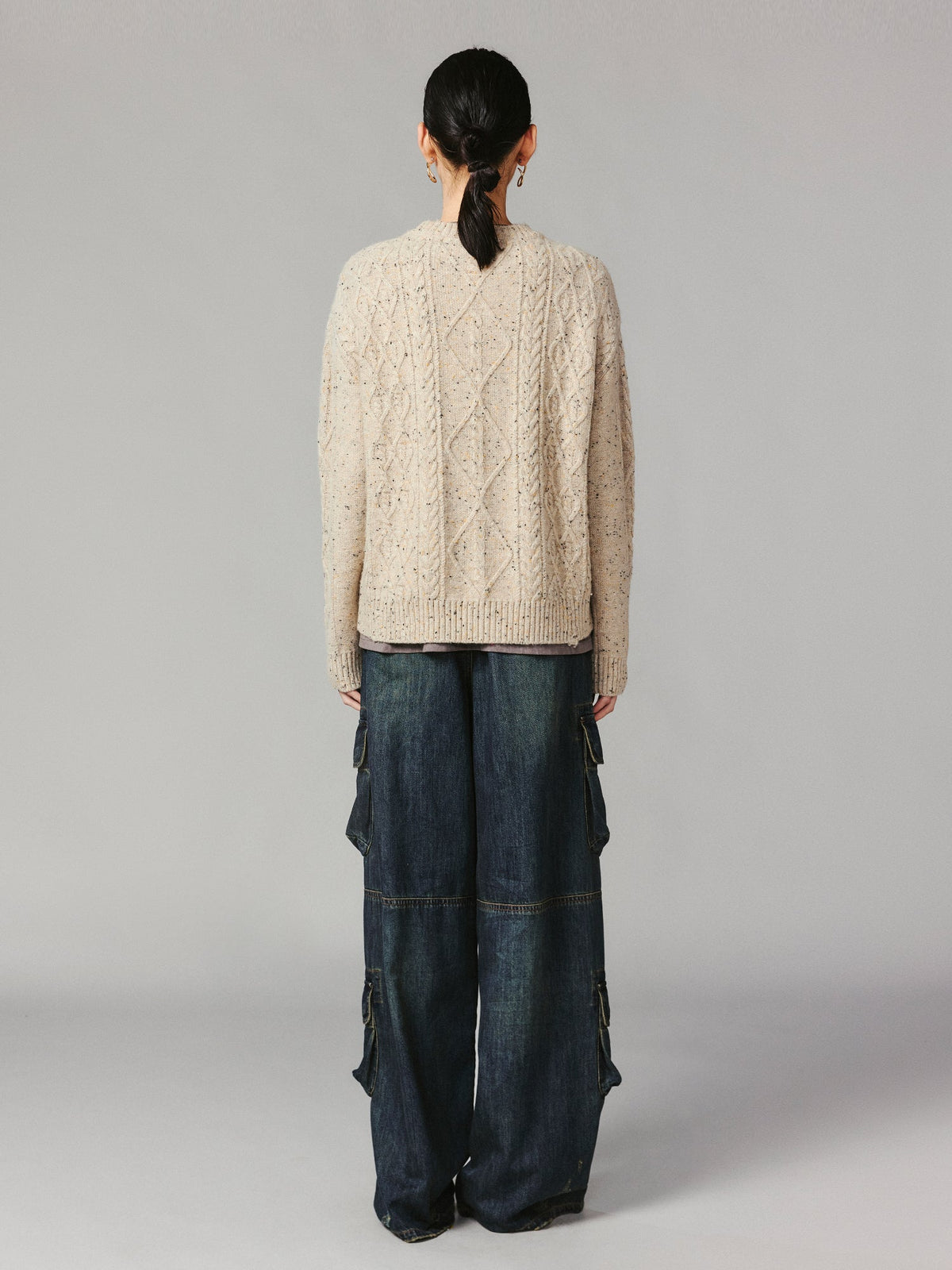 Teddy bear peeking through sweater