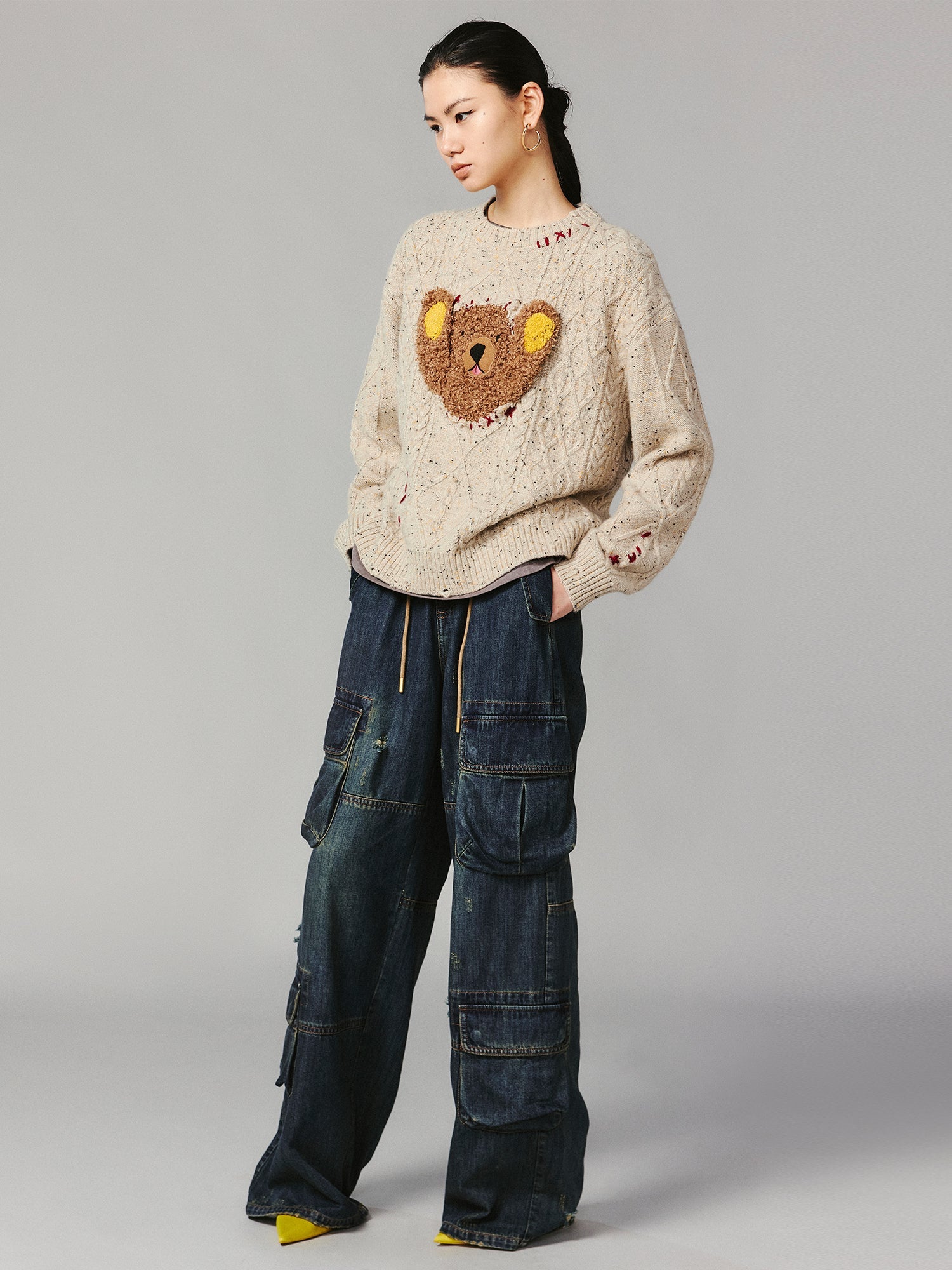 Teddy bear peeking through sweater