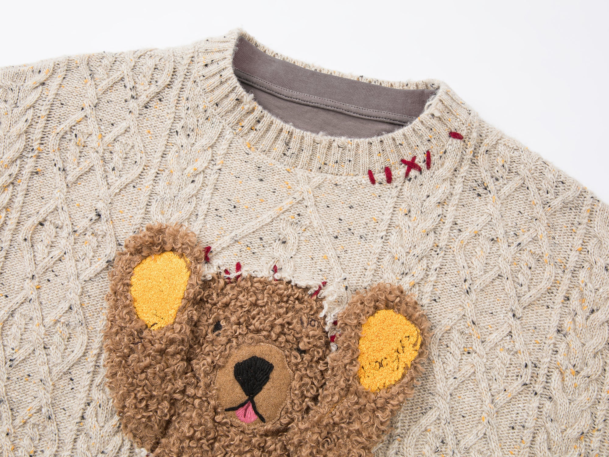 Teddy bear peeking through sweater