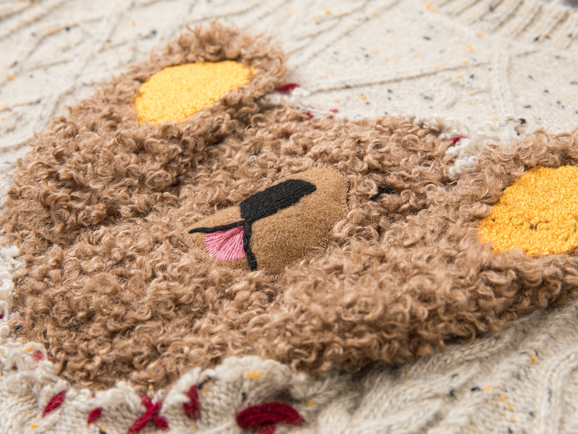 Teddy bear peeking through sweater