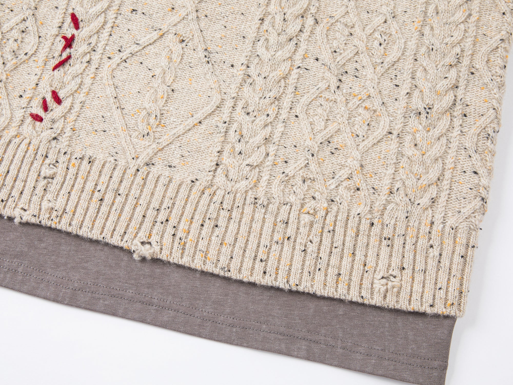 Teddy bear peeking through sweater