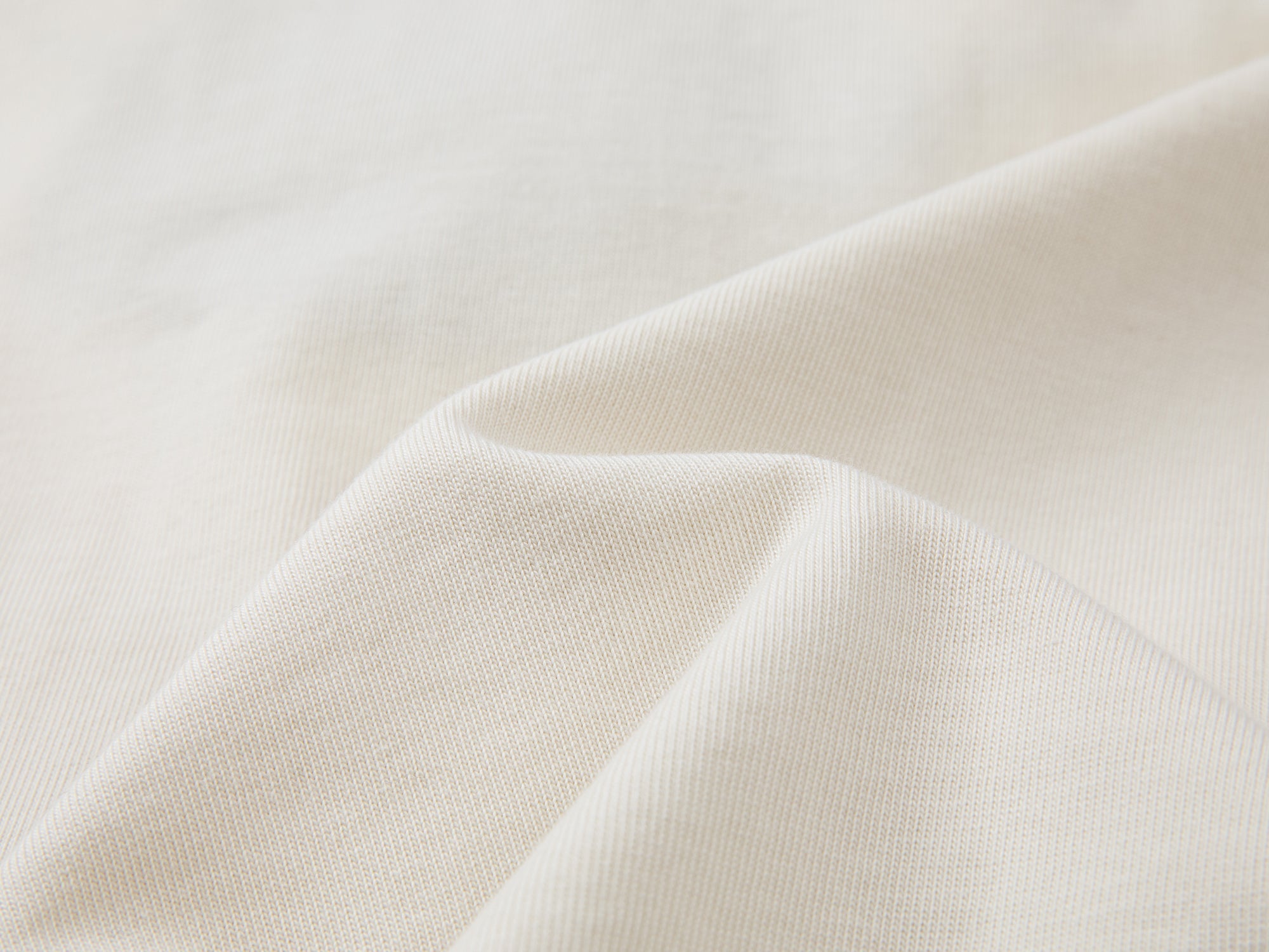 Teddy bear peeking through long-sleeve T-shirt