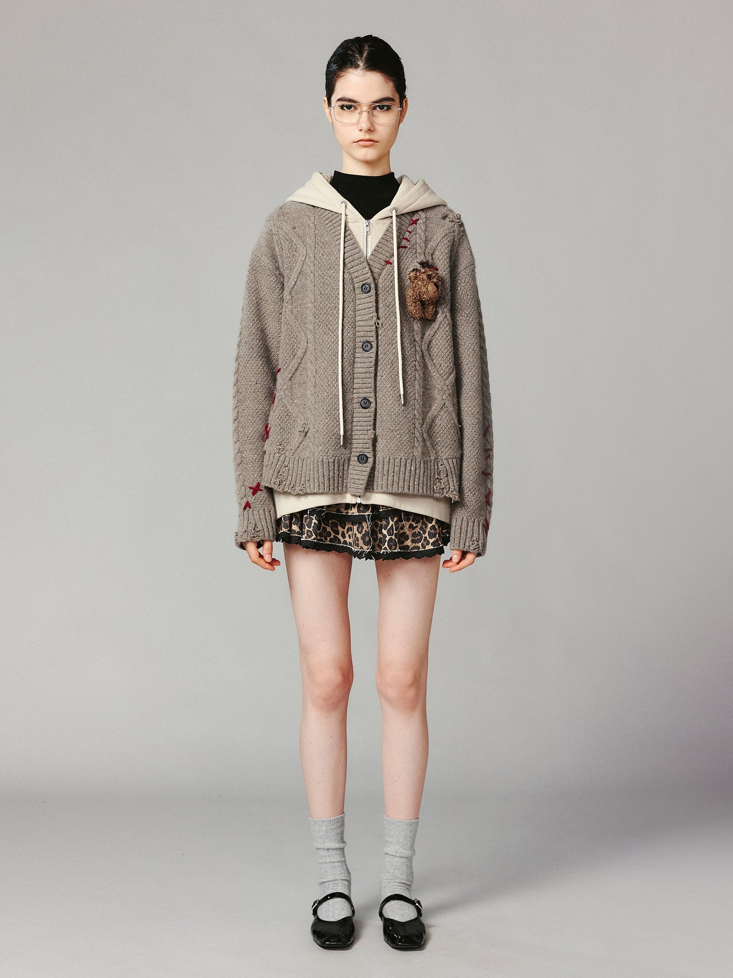 Layered look cable-knit hoodie with 3D bear peeking through