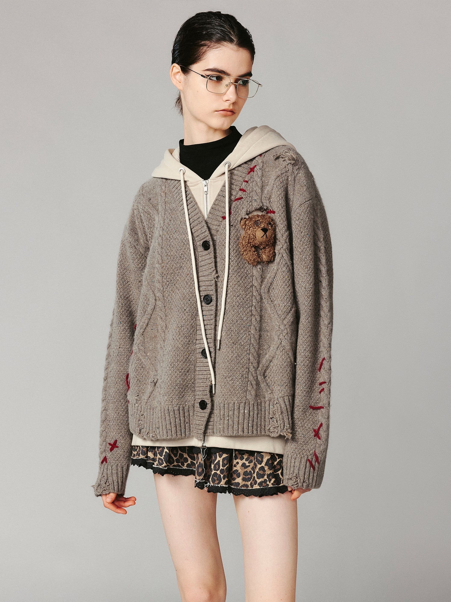 Layered look cable-knit hoodie with 3D bear peeking through
