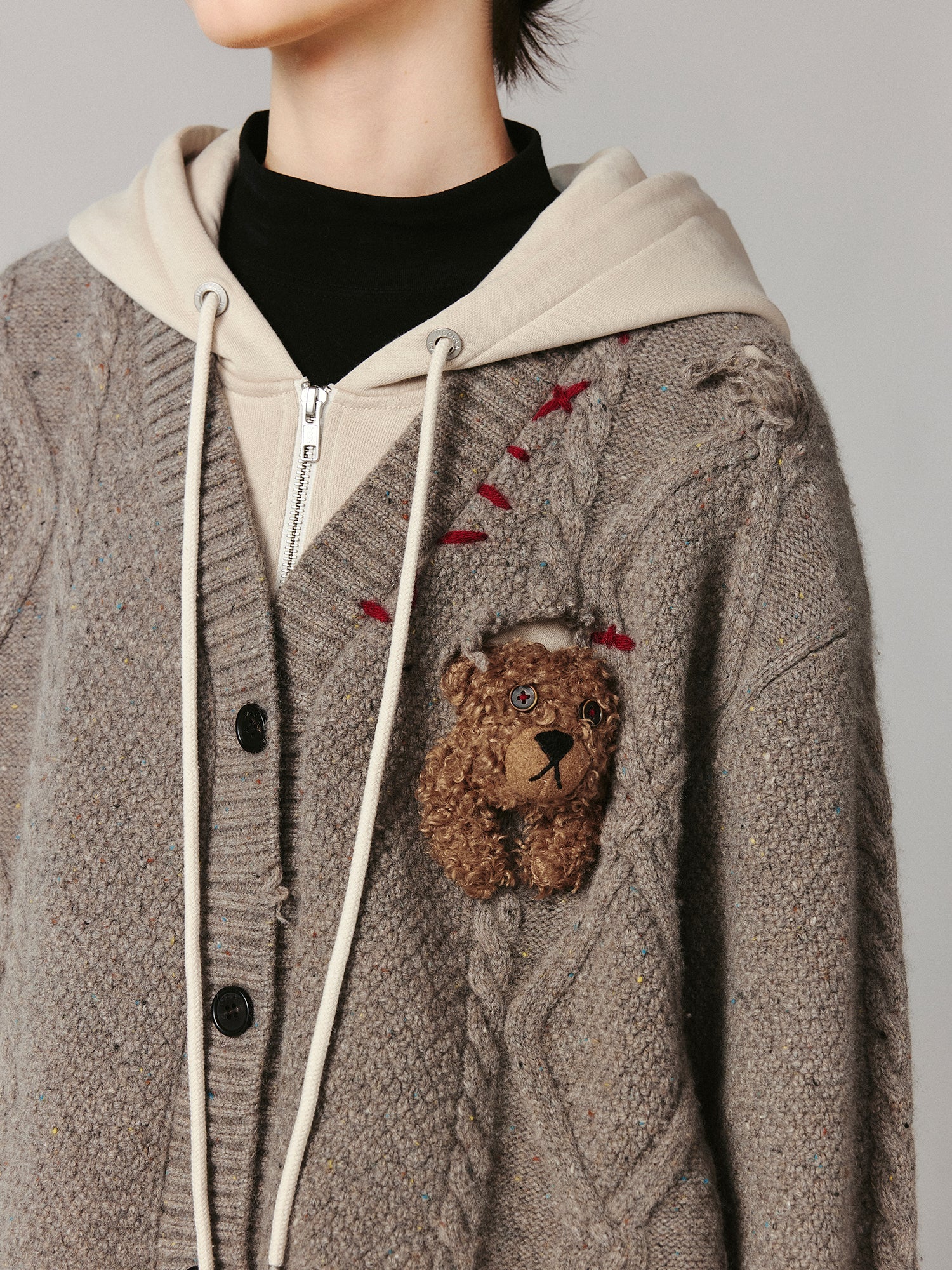 Layered look cable-knit hoodie with 3D bear peeking through