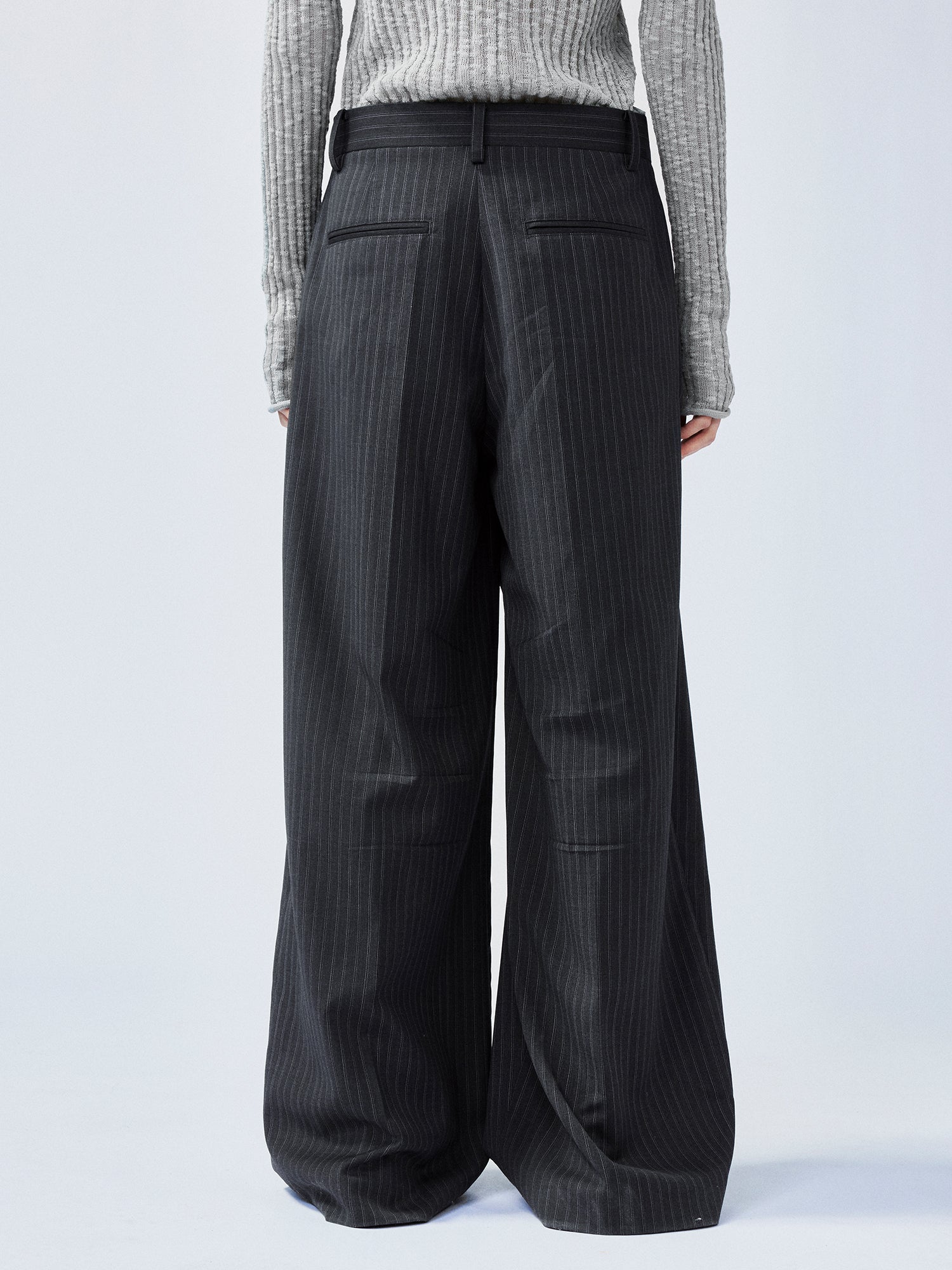 Pulled pleated suit pants with authentic wear marks