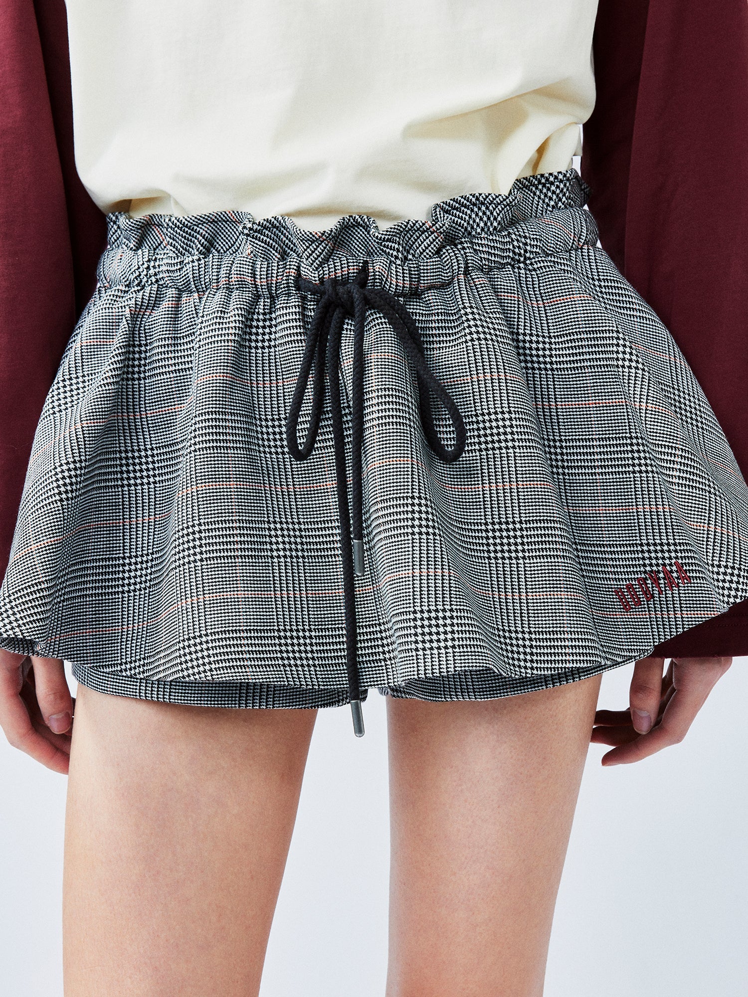 Playful and stylish finely woven plaid mini skirt with a hidden twist