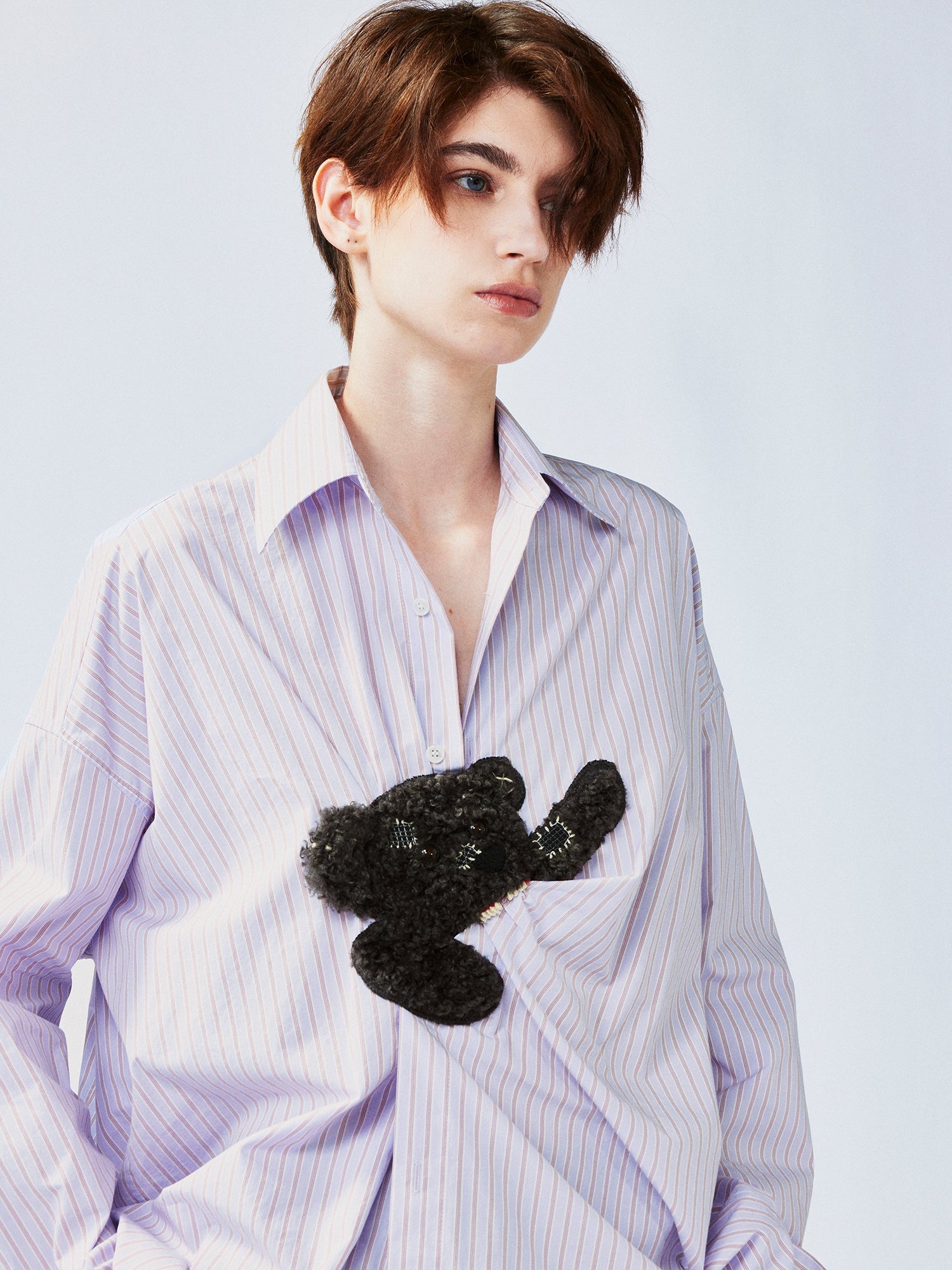 Playful puppy biting shirt