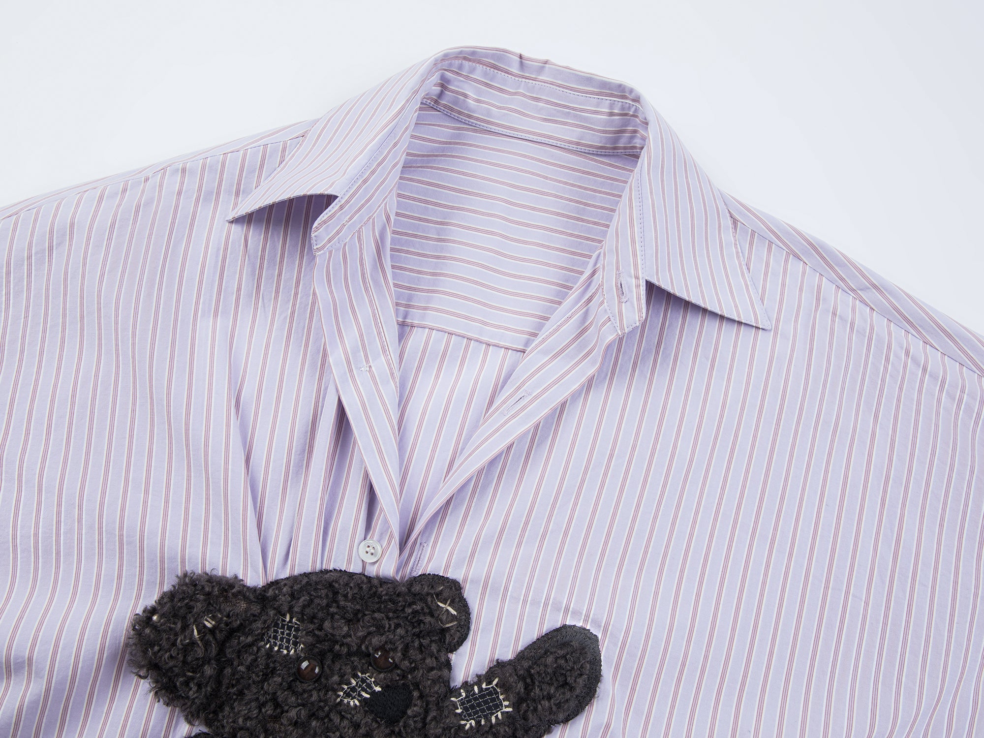 Playful puppy biting shirt