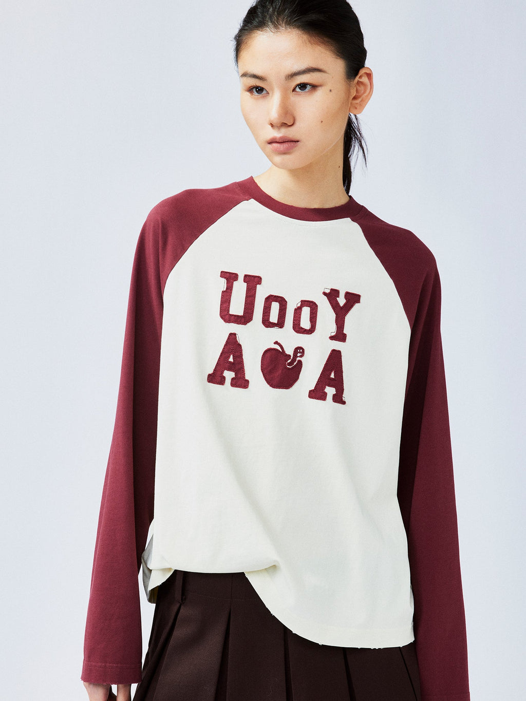 遊び心のあるアップルワームのラグランスリーブTシャツ