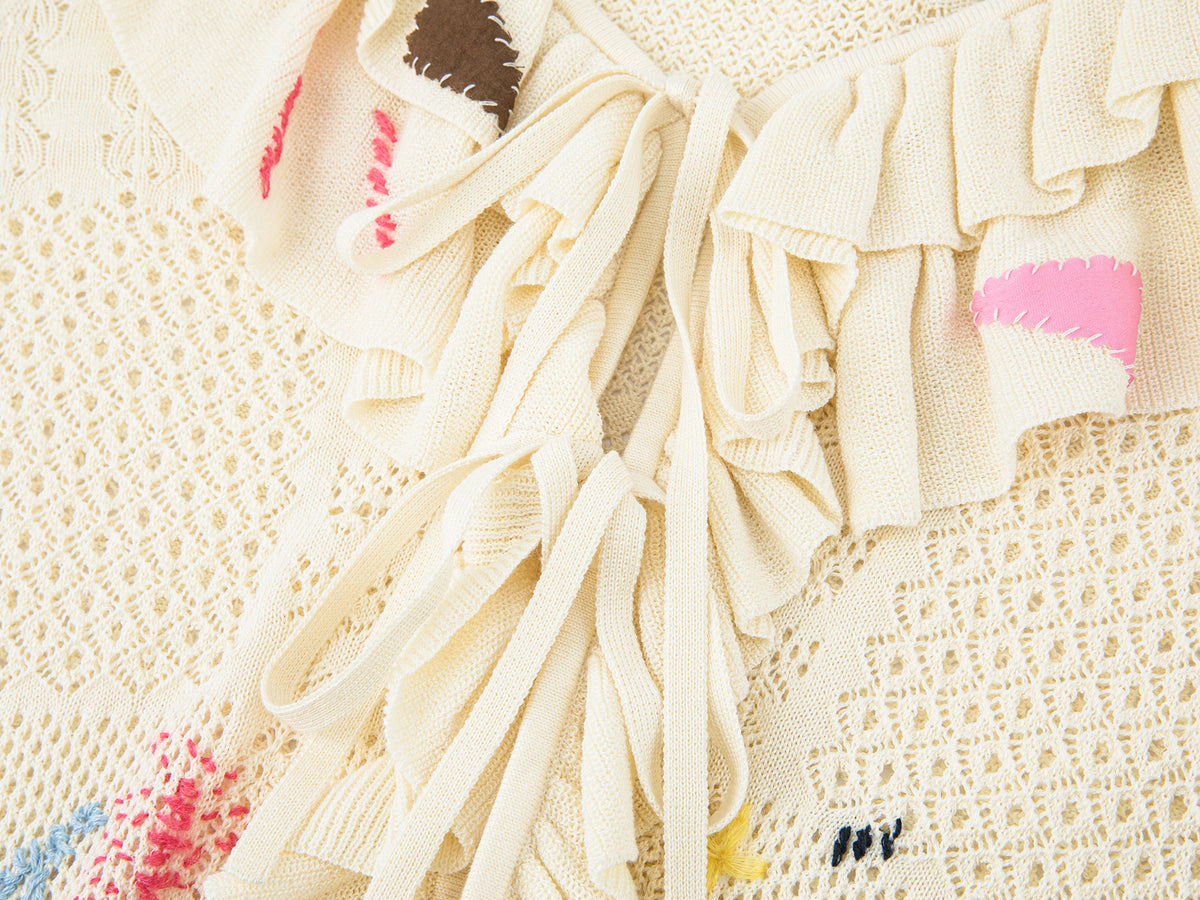 Handcrafted patch cardigan with ruffled edges