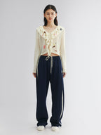 Handcrafted patch cardigan with ruffled edges