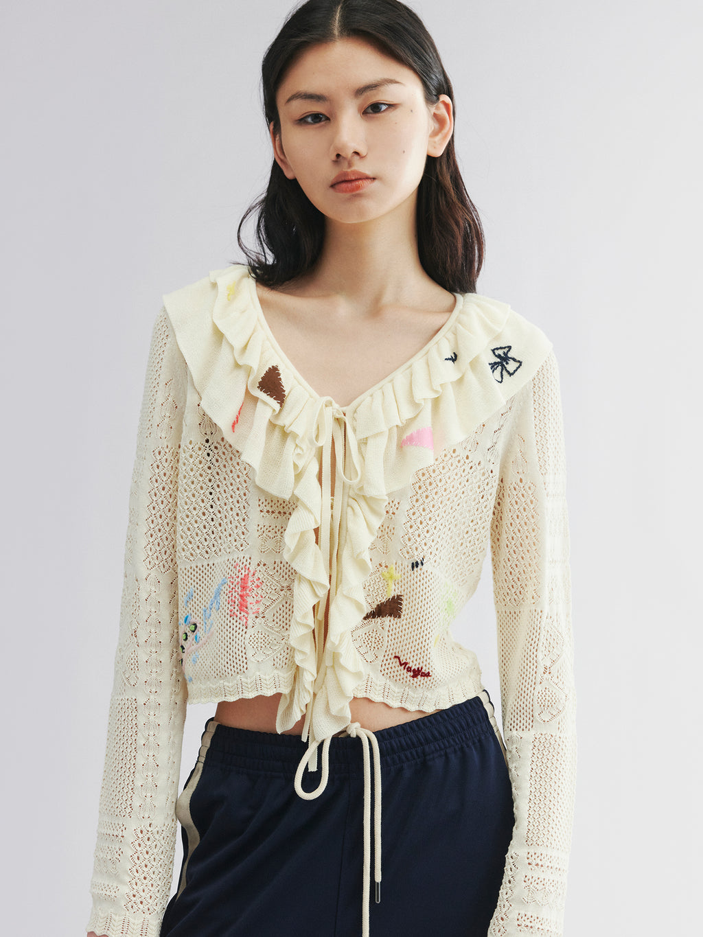 Handcrafted patch cardigan with ruffled edges