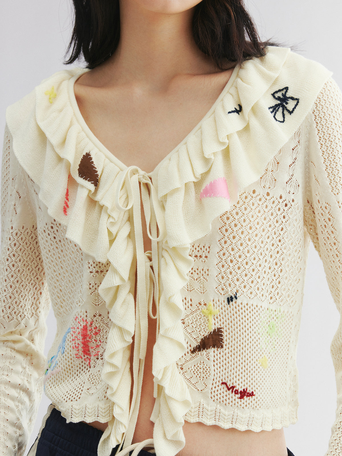 Handcrafted patch cardigan with ruffled edges