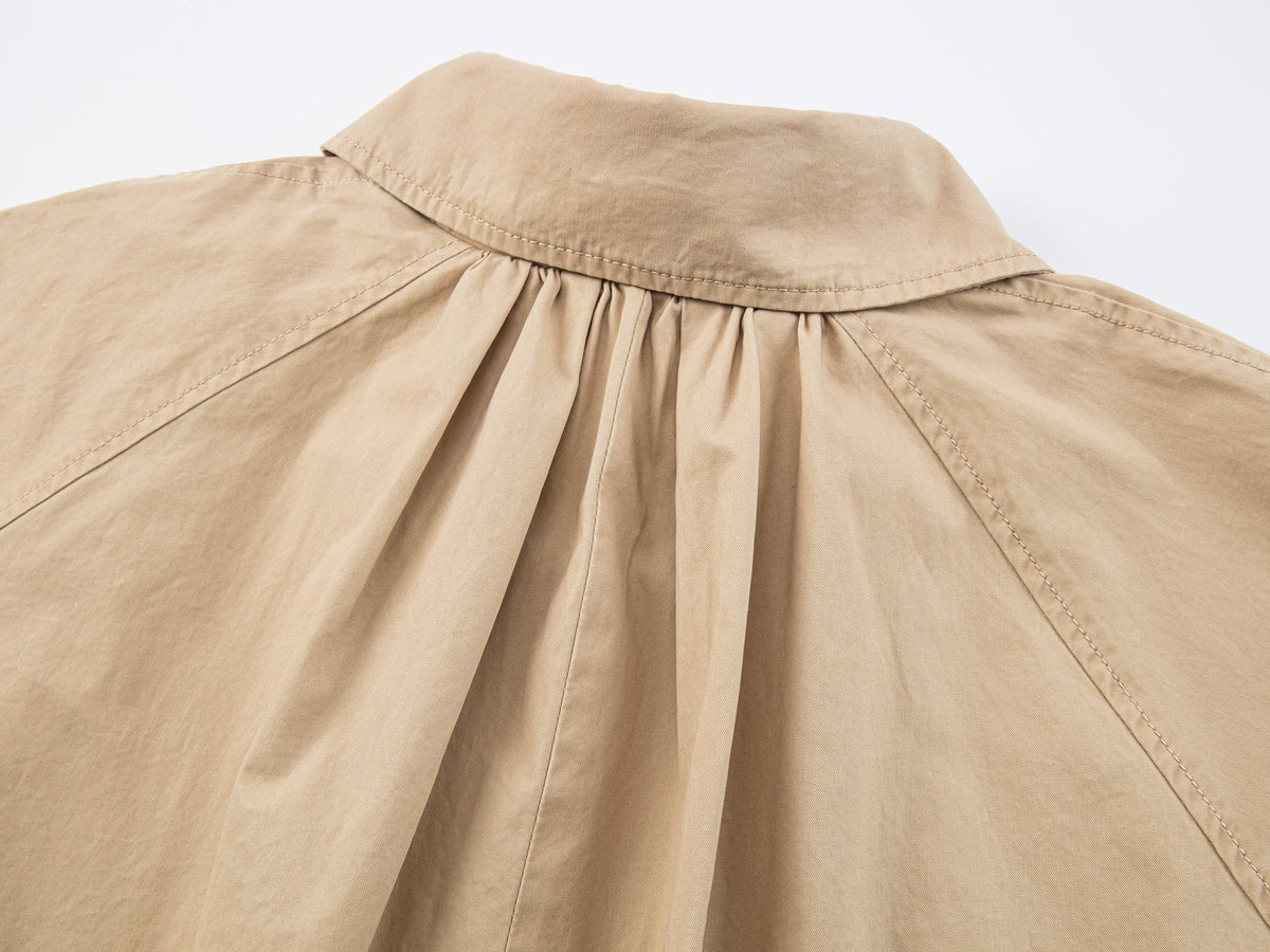 Exposed-lining balmacaan trench coat