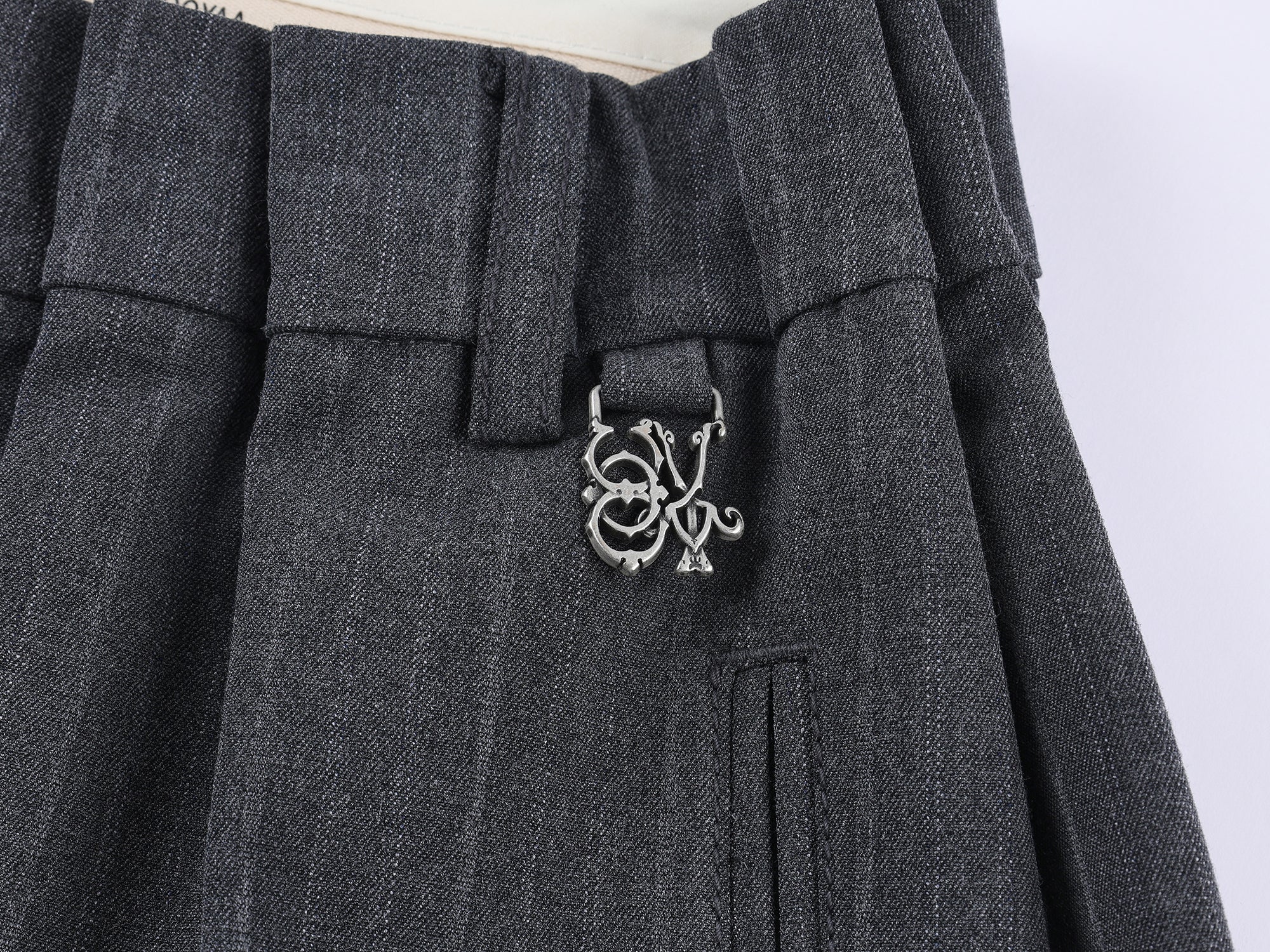 Draped tailored trousers with curved pleats