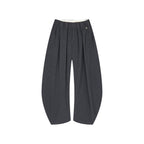 Draped tailored trousers with curved pleats