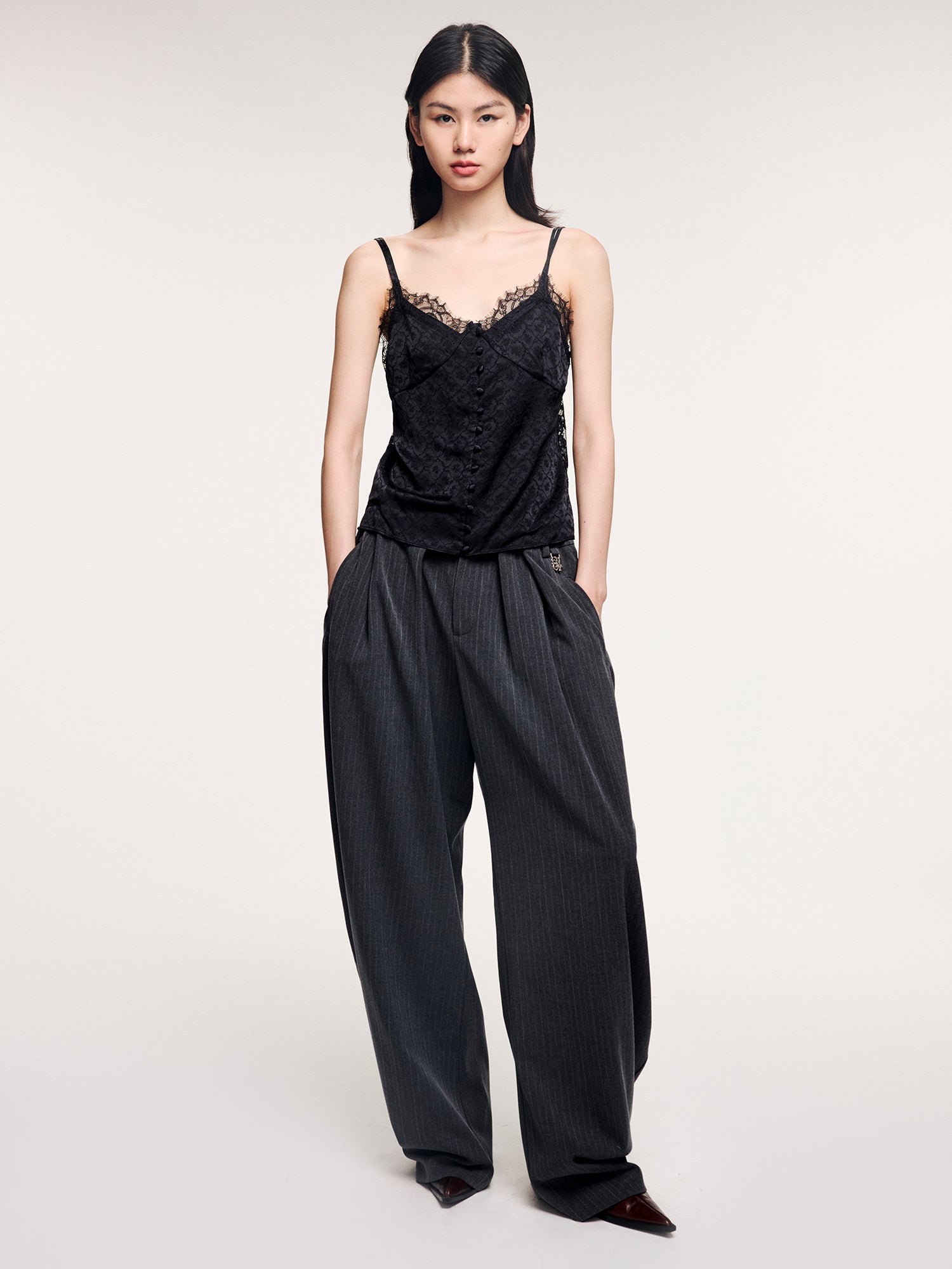 Draped tailored trousers with curved pleats