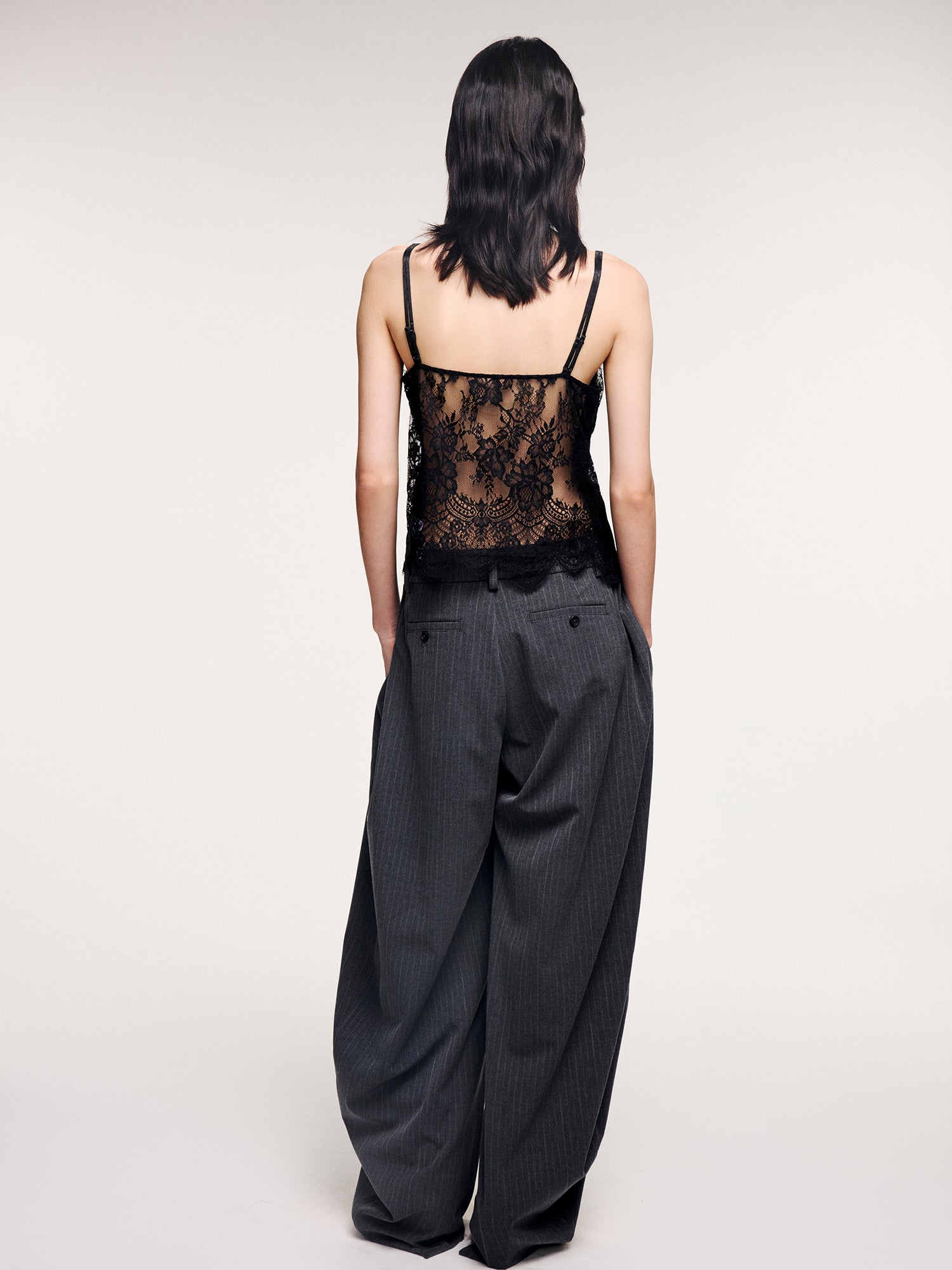 Draped tailored trousers with curved pleats
