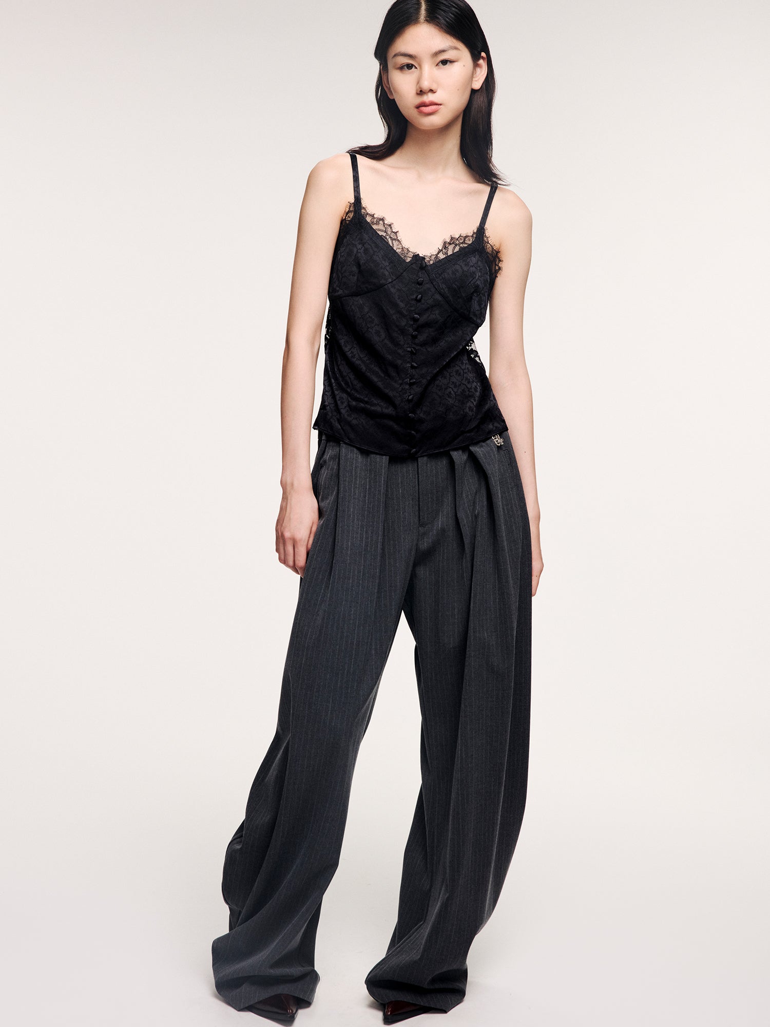 Draped tailored trousers with curved pleats