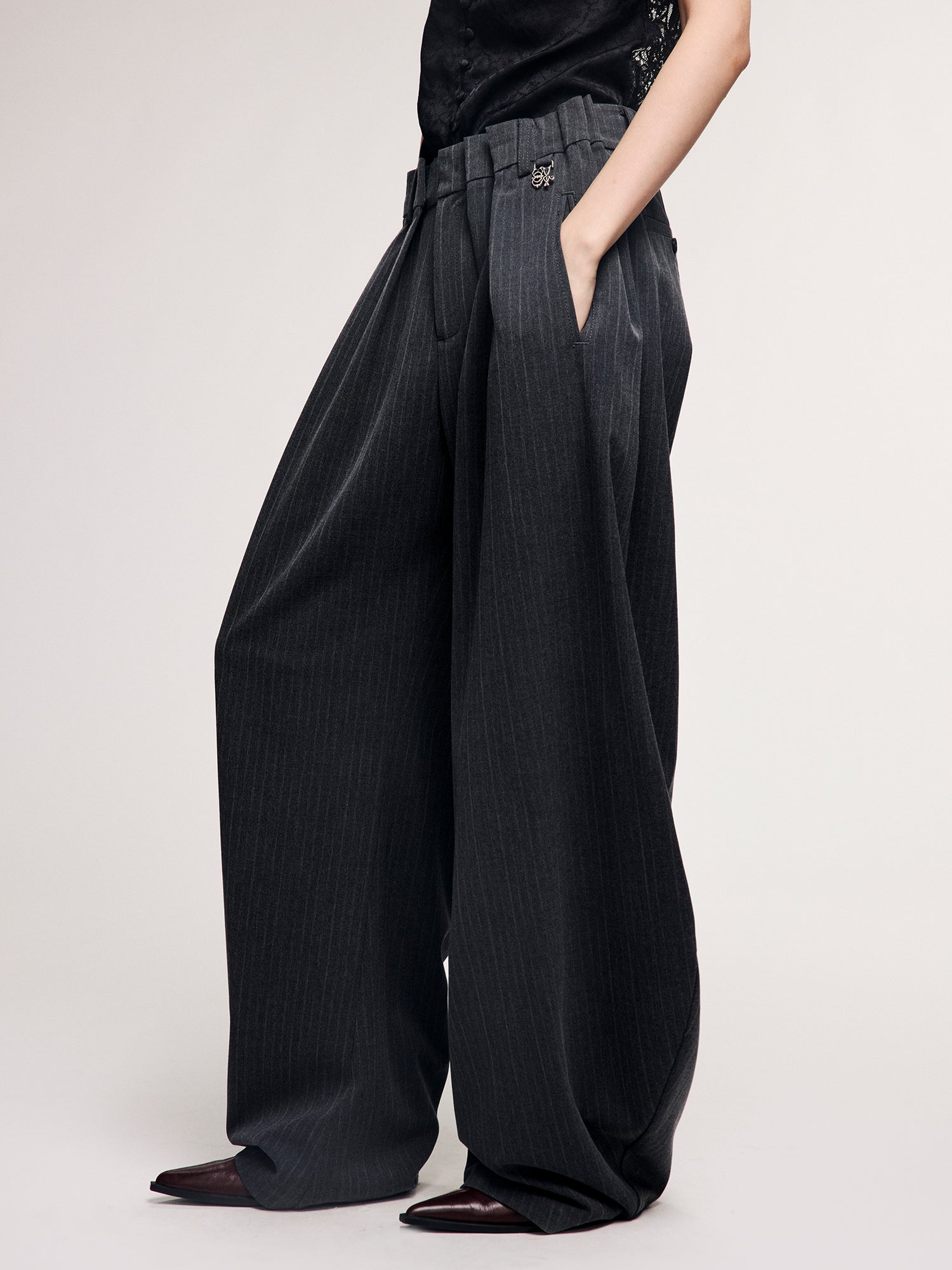 Draped tailored trousers with curved pleats
