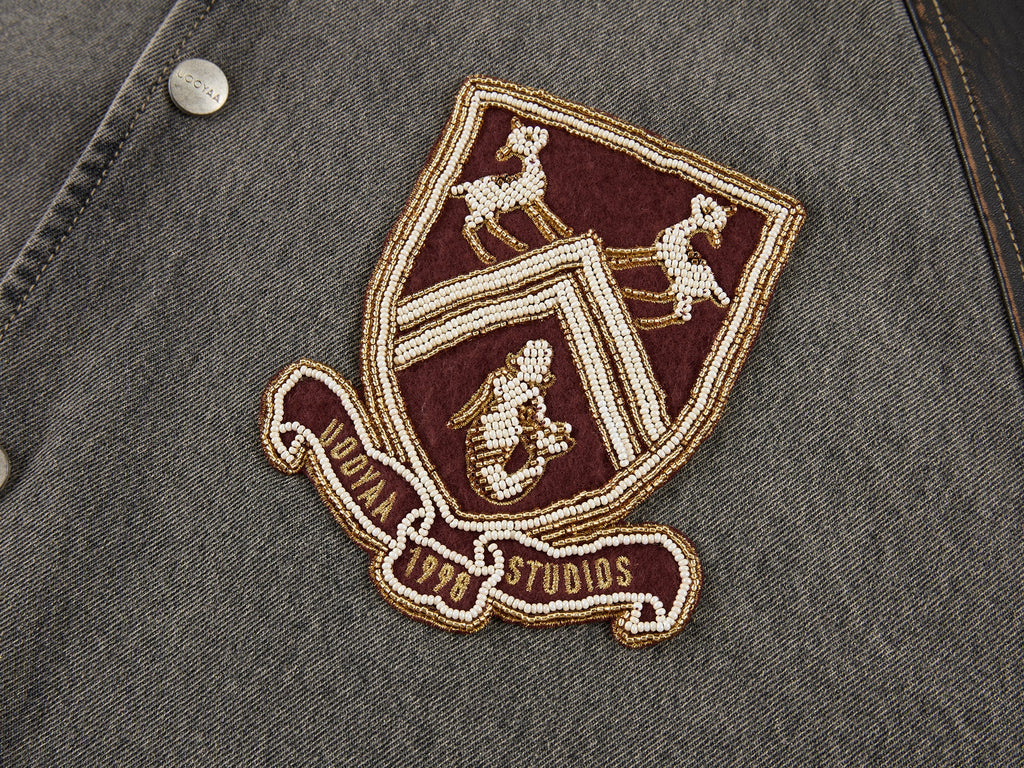 Baseball jacket with leather sleeves and badges