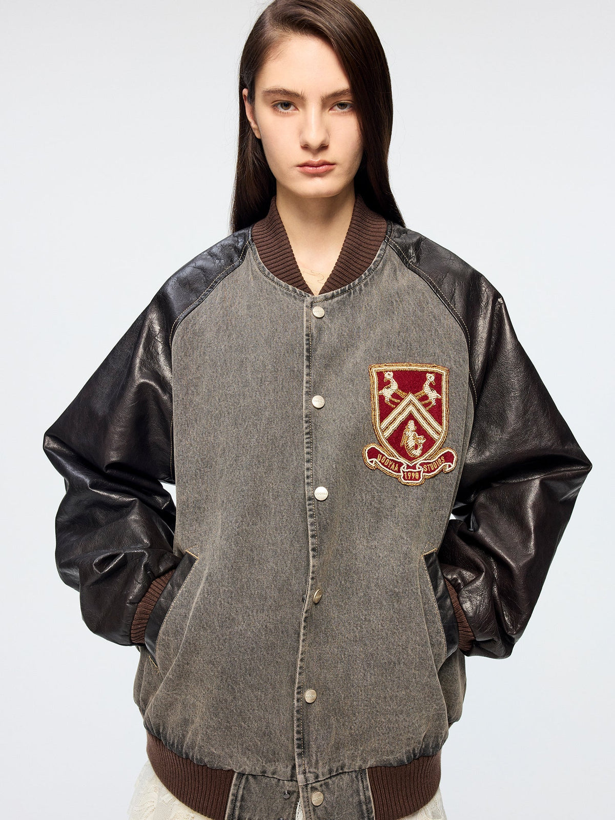 Baseball jacket with leather sleeves and badges