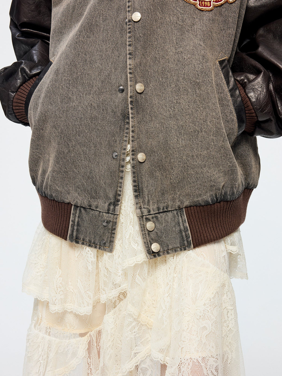 Baseball jacket with leather sleeves and badges