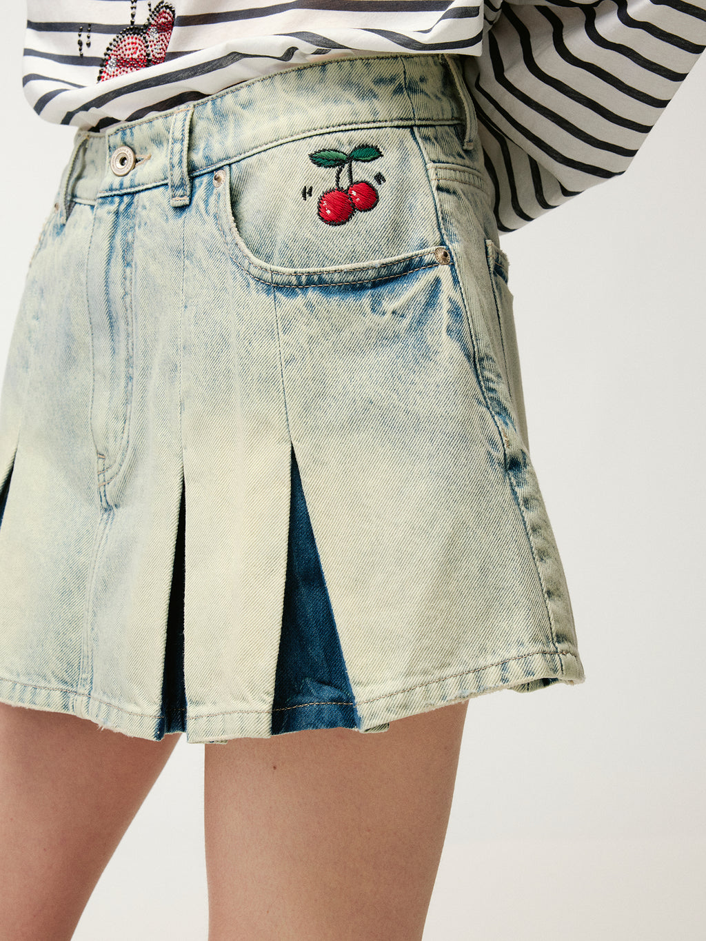 Washed pleated denim mini skirt