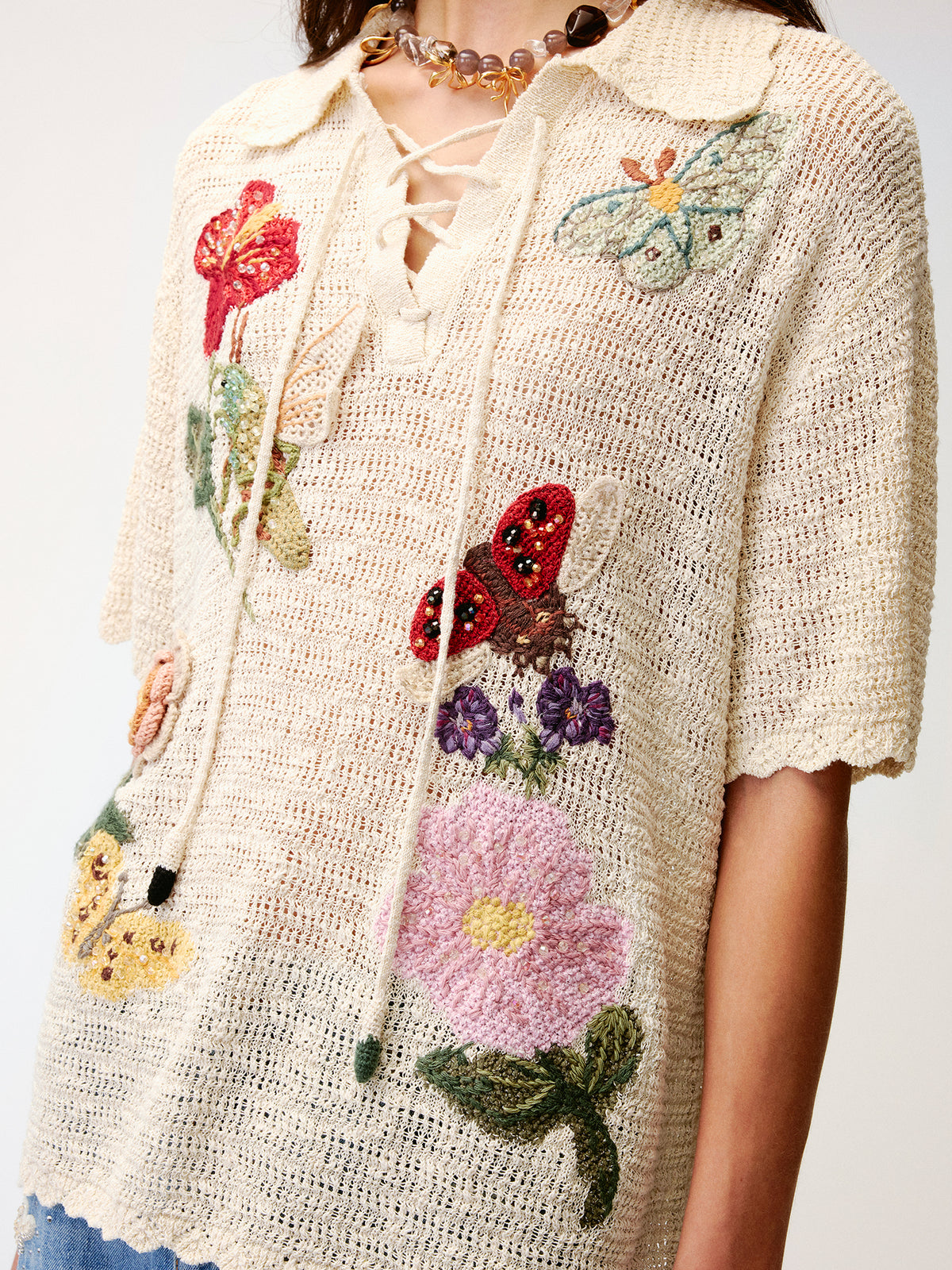 Hand-crocheted insect and floral tie-front polo knit shirt