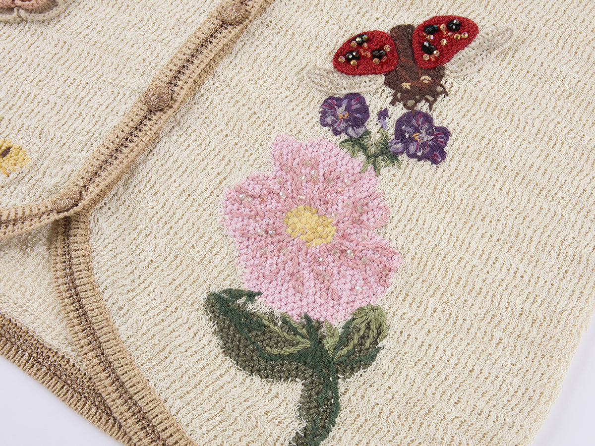 Hand-crocheted insect and floral cardigan