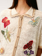 Hand-crocheted insect and floral cardigan