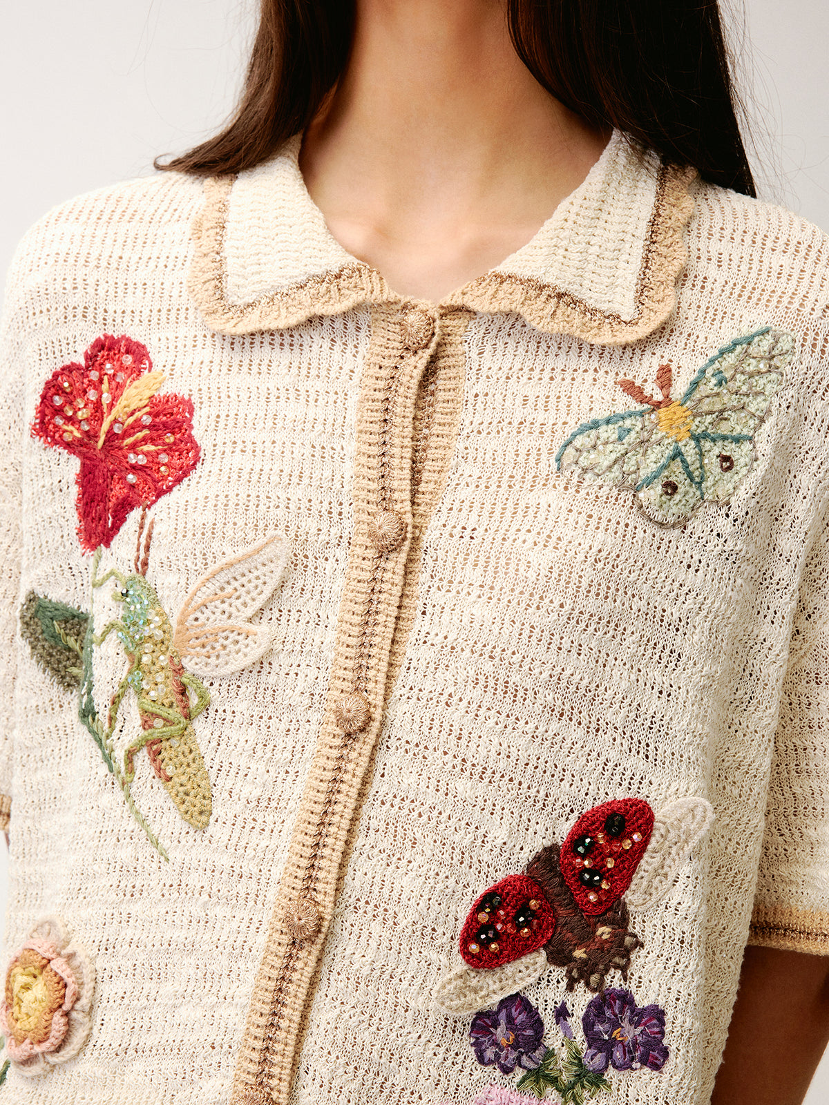 Hand-crocheted insect and floral cardigan