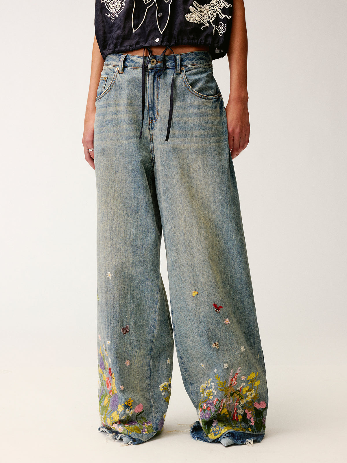 Insect and floral embroidered denim pants