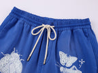 Lace insect and floral motif curved denim pants