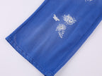 Lace insect and floral motif curved denim pants