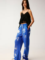 Lace insect and floral motif curved denim pants