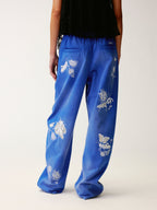 Lace insect and floral motif curved denim pants