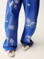Lace insect and floral motif curved denim pants